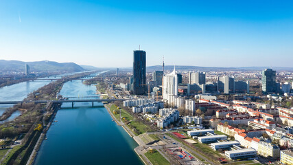 Vienna Danube and City aerial panoramic view. Donaustadt Kagran district at the Danube. Modern city...