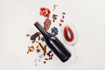 Poster Composition with wine bottle, glass and possible flavor components of red wine © Diana Vyshniakova