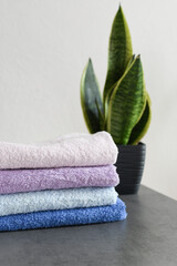 Obraz na płótnie Canvas A stack of fresh towels on the bathroom table. Copy space