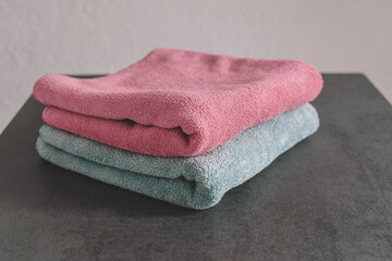 A stack of fresh towels on the bathroom table. Copy space
