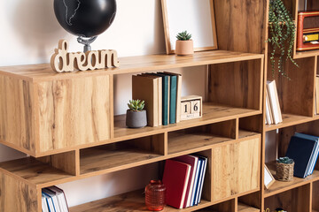 Modern shelf unit with books and decor, closeup