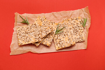 Tasty crackers with seeds on color background