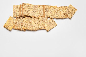 Tasty crackers with seeds on white background