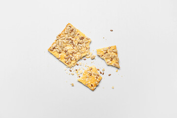Tasty cracker with seeds on white background