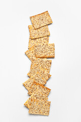 Tasty crackers with seeds on white background