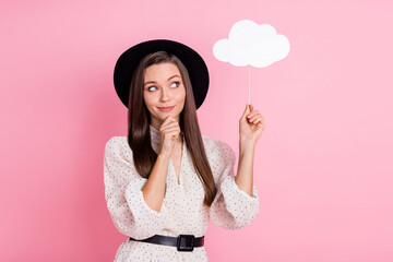 Photo of pretty thoughtful young lady wear white outfit cap holding mind cloud looking empty space isolated pink color background