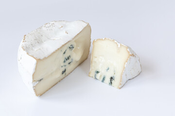 Camembert or brie cheese isolated on white background. Soft cheese covered with edible white mold. Gourmet blue cheese.