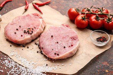 Fresh raw meat and spices on grunge background