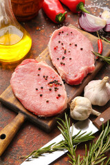 Board with fresh raw meat and spices on grunge background