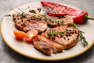 Plate with tasty steak and spices on grey background, closeup