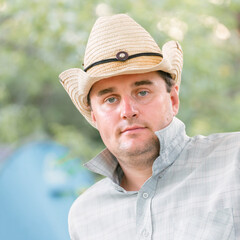 portrait of a handsome young man in a sombrero on a summer day.