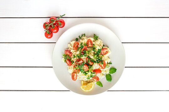 Fresh home-made tabouli, or tabbouleh salad, top view on white wooden background with copy spaces