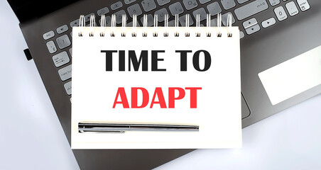 TIME TO ADAPT - Top view notebook writing on the laptop