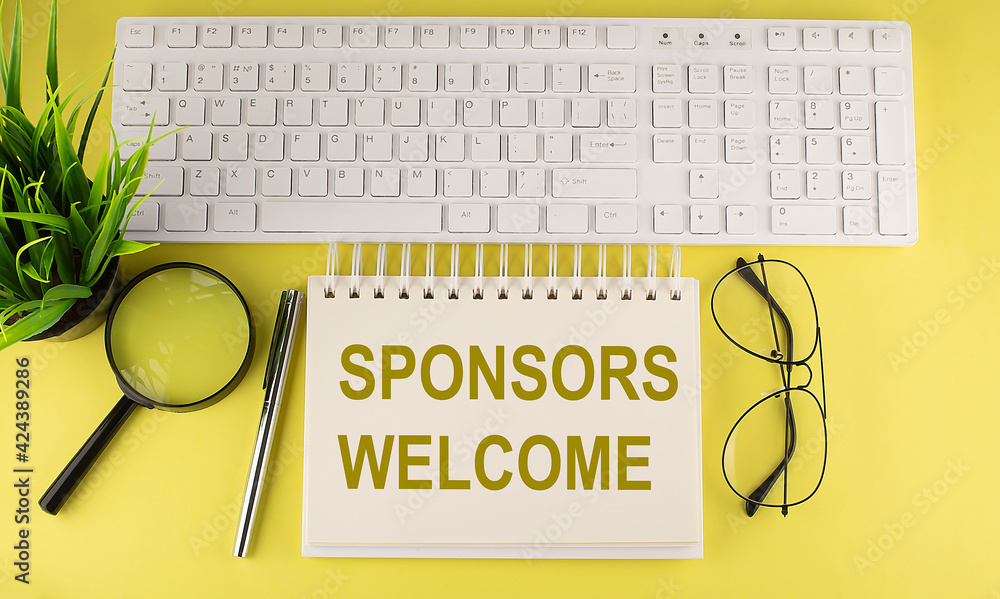 Poster office desk table top view with keyboard and notebook text sponsors welcome on the yellow background