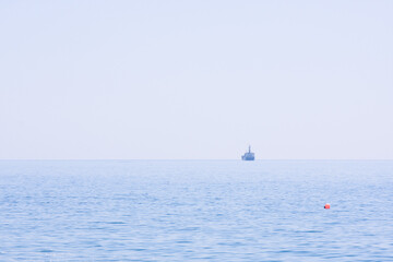 Ships on the seascape horizon, natural blue background, pure sky