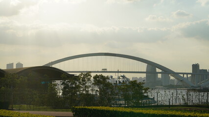 The arched steel bridge view located on the river of one city