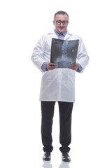 in full growth. smiling male doctor looking at an x- ray