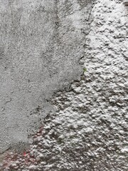 Concrete wall painted with silver emulsion.