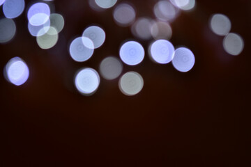 Bokeh circles on a dark background. Abstract image. Blurred image. Christmas lights. Overlay