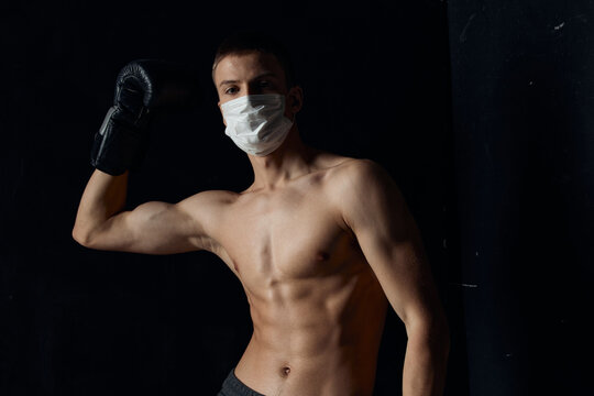 portrait of a boxer in a medical mask and black gloves Copy Space