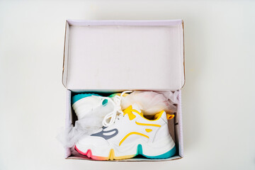 new multi-colored sneakers in box on a white background. 