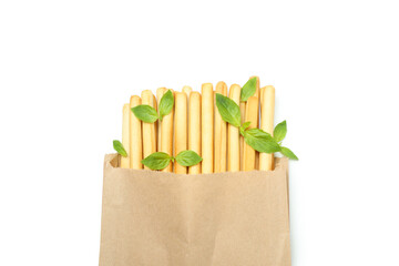 Paper bag with grissini breadsticks isolated on white background