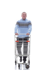 in full growth. confident casual man with shopping cart