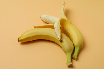 Two bananas on beige background, space for text