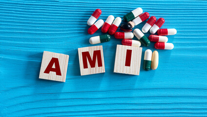 AMI - acronym on wooden cubes on a blue background with tablets