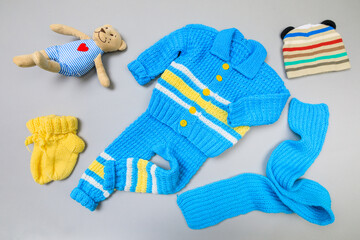 Baby concept. handmade knitted suit for baby on grey  background. Place for text. View from above. Flat Lay - Image