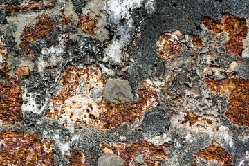 Old worn eroded stained brick concrete wall, with beautiful pattern and texture