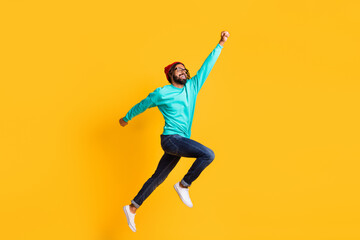 Fototapeta na wymiar Full body profile side photo of young african man happy positive smile jump up superhero isolated over yellow color background