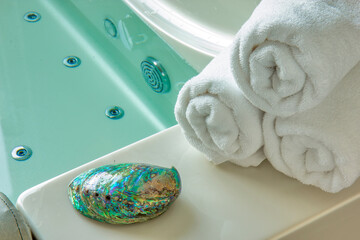 Sea shell and towel on the hot tub