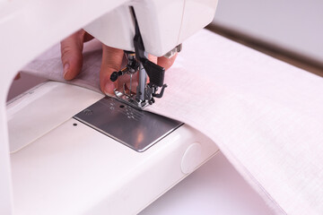 Close-up image of seamstress. Seamstress sews fulfills an order. Small business.