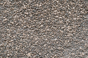 gravel crushed stone background, texture of gravel wall of abstract look brown color