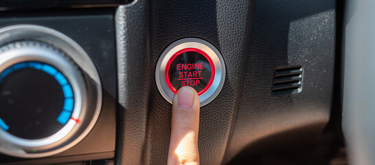 Finger press a car ignition button or START engine inside modern electric automobile. Keyless, change, strategy, vision, innovation and future concept - obrazy, fototapety, plakaty