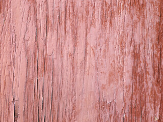 Old wood background with cracked pink paint.