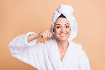 Photo of joyful happy young woman brush teeth toothbrush bathroom isolated on pastel beige color...