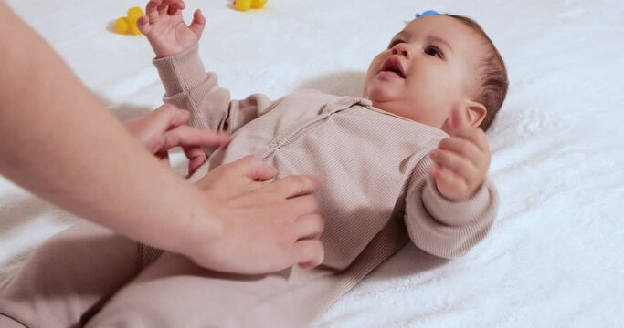 infant, childhood concept - close-up of smiling happy Baby plays with a teether. Teeth cutting. First teeth. Joy toothless 7 months baby bite, gnaws teether toy