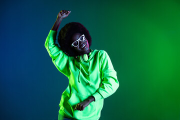 Photo of vintage 90s lady carefree dance wear headphones glasses hoodie isolated gradient green...