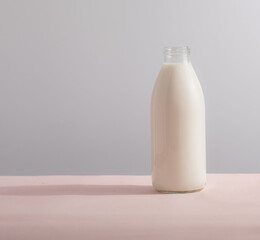 Traditional glass milk bottle on a table on a light background