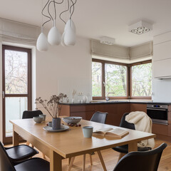 Wooden dining table with decorations in kitchen