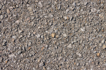 Zoom View Gravel or Pebble on Asphalt Road Texture Background in Natural Light