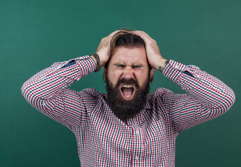 brutal man with beard having headache. informal education. male student sit in classroom while lesson. pass the exam. sick and tired. learning the subject. back to school. happy teachers day