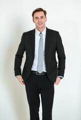 Fototapeta premium Portrait photo of young businessman in black suit studio shot isolated on white background looking straight at camera with confidence and positvie smile on happy face. Concept for modern man