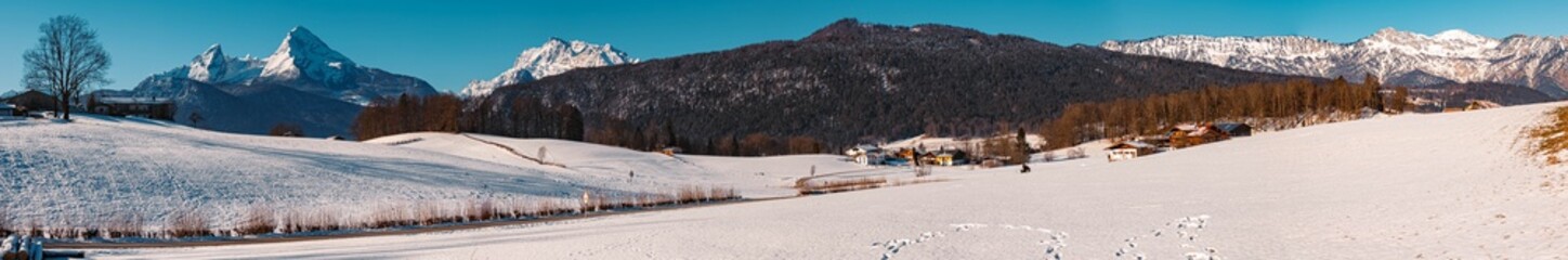 High resolution stitched panorama of a beautiful winter landscape with the famous Watzmann and Hochkalter summits in the background on a sunny morning near Berchtesgaden, Bavaria, Germany