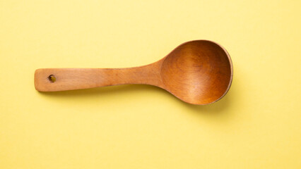 wooden spoon for food on a colored background. old vintage spoon