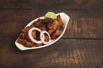 Delicious spicy Chicken Kabab Indian food on wooden table	
