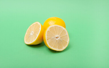 Sliced lemon on a green background