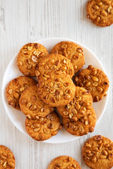 Homemade Cookies with Peanuts on a white plate, top view. Flat lay, overhead, from above.